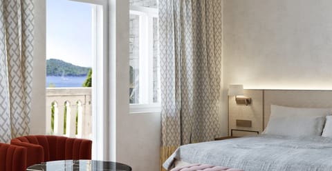 Deluxe Room, Balcony, Sea View | Minibar, in-room safe, desk, free WiFi