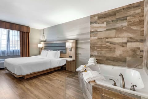 Suite, 1 King Bed, Non Smoking, Jetted Tub | Desk, laptop workspace, blackout drapes, iron/ironing board