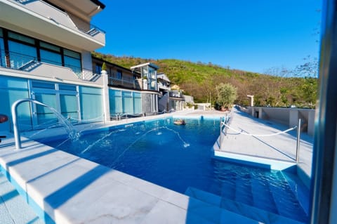 Seasonal outdoor pool, open 9:00 AM to 7:00 PM, pool umbrellas
