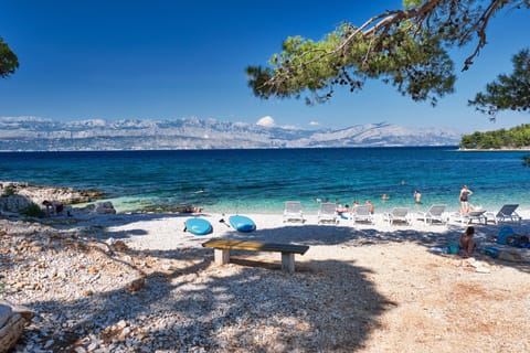 On the beach, white sand, beach umbrellas, beach bar