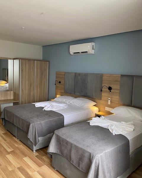 Deluxe Triple Room, Sea View | Minibar, in-room safe, desk, blackout drapes