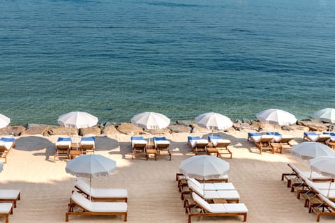 On the beach, sun loungers, beach umbrellas