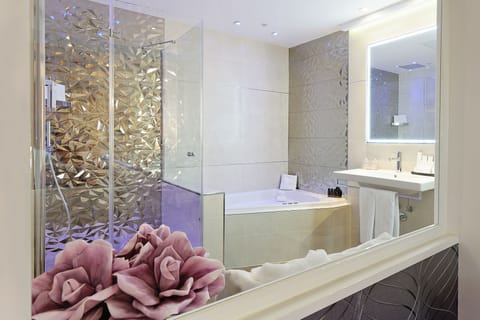 Shower, designer toiletries, hair dryer, towels