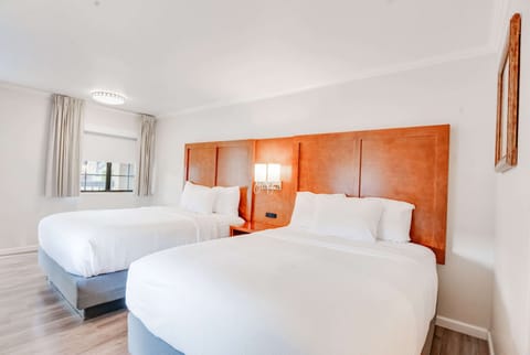 Premium bedding, desk, laptop workspace, blackout drapes