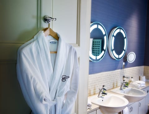 Designer toiletries, hair dryer, slippers, towels