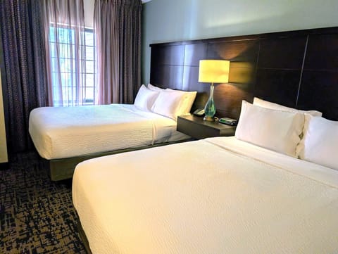 Premium bedding, desk, laptop workspace, blackout drapes