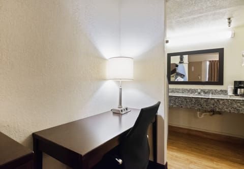 Desk, laptop workspace, blackout drapes, iron/ironing board