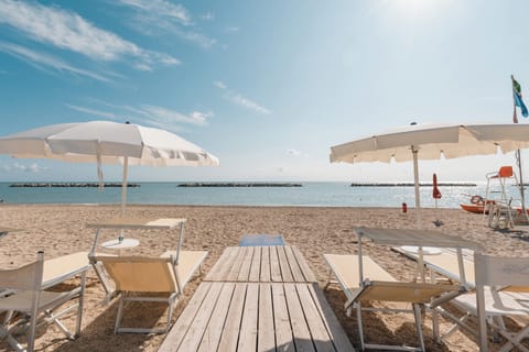 Private beach, sun loungers, beach umbrellas, windsurfing