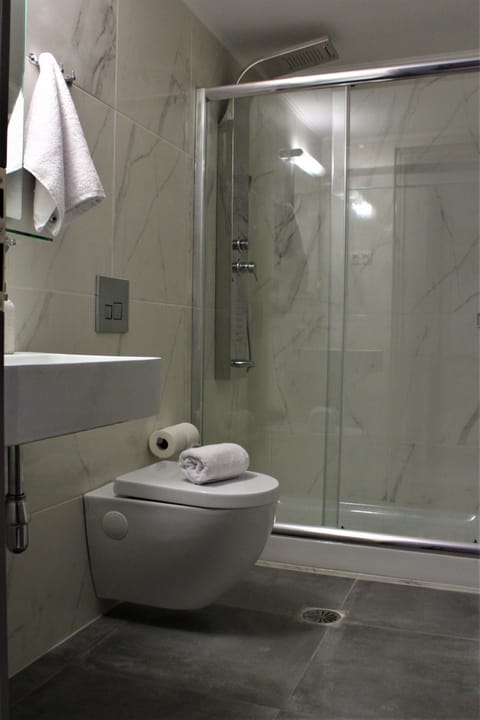 Shower, hair dryer, slippers, towels