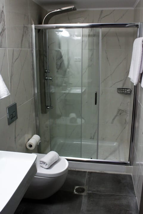 Shower, hair dryer, slippers, towels