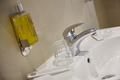 Deep soaking tub, rainfall showerhead, eco-friendly toiletries