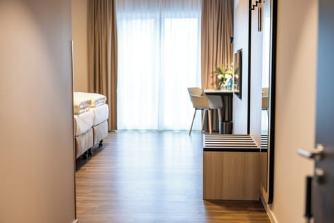 Hypo-allergenic bedding, desk, laptop workspace, blackout drapes