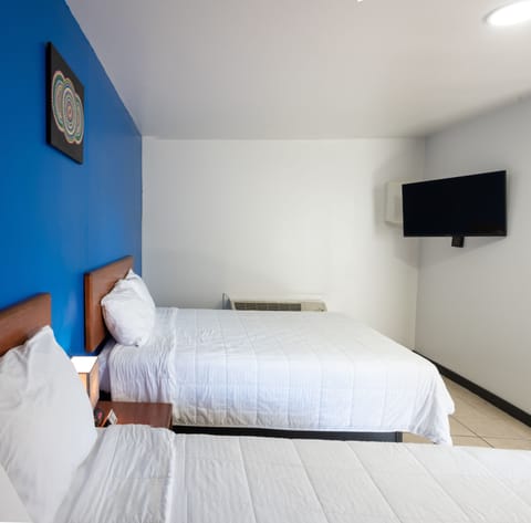 Standard Quadruple Room, 2 Queen Beds, Non Smoking, Refrigerator & Microwave | Desk, iron/ironing board, free WiFi, bed sheets