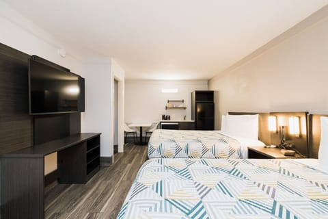 Premium bedding, desk, laptop workspace, blackout drapes