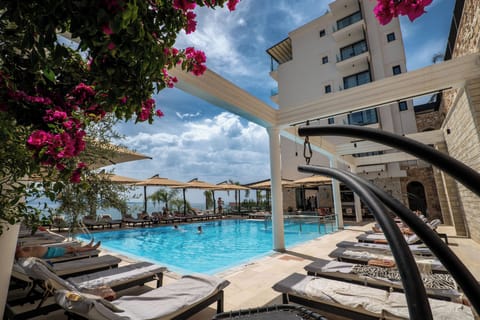 Seasonal outdoor pool, open 8:00 AM to 8:00 PM, pool umbrellas