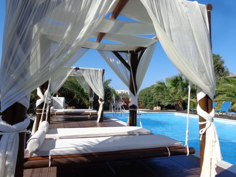 Seasonal outdoor pool, open 8:30 AM to 8:00 PM, pool umbrellas