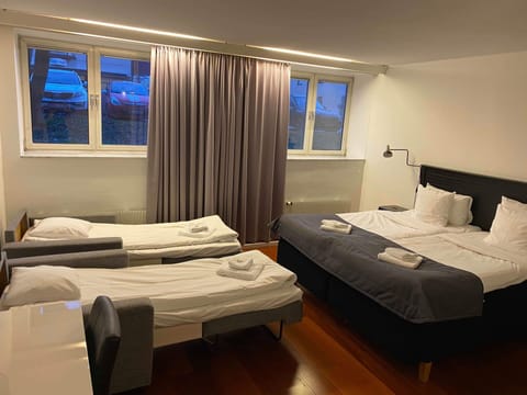 Family Quadruple Room | Desk, blackout drapes, iron/ironing board (on request), WiFi (free)