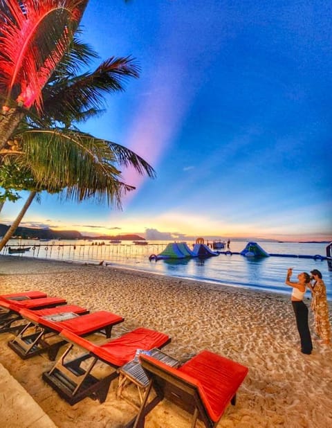 On the beach, white sand, sun loungers, beach umbrellas