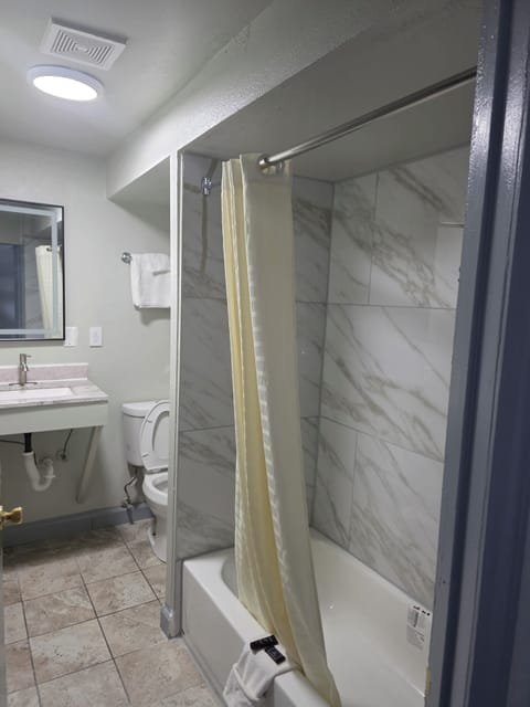 Economy Single Room, Smoking | Bathroom | Combined shower/tub, hair dryer, towels, soap