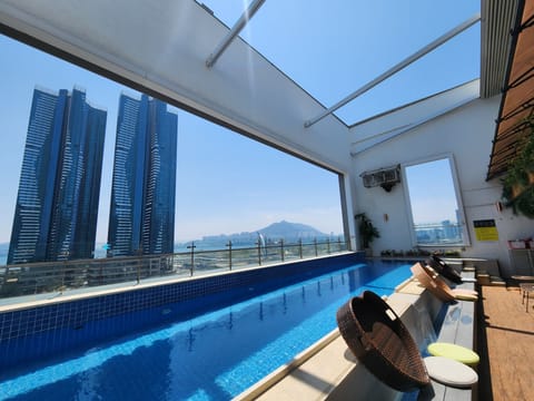 Outdoor pool, open 7:00 AM to midnight, pool umbrellas, sun loungers
