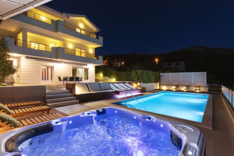 Outdoor pool, a heated pool, pool umbrellas, sun loungers