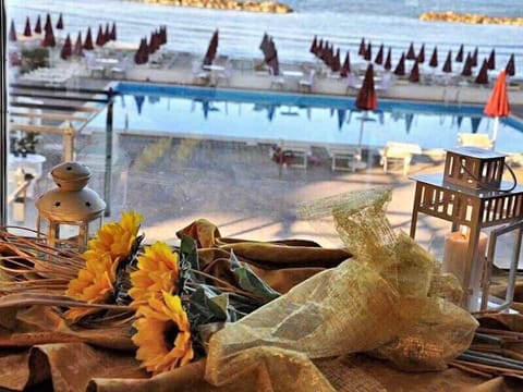 Outdoor pool, open 10:00 AM to 6:00 PM, pool umbrellas, sun loungers