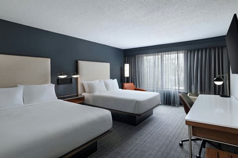 Premium bedding, desk, laptop workspace, blackout drapes