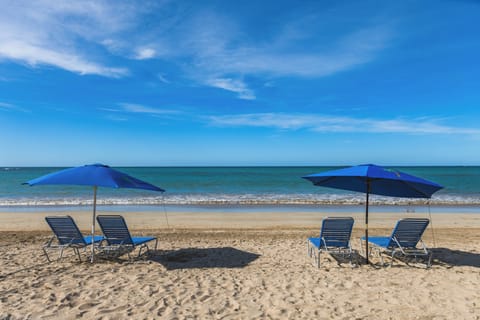 Beach nearby, white sand, beach umbrellas, beach towels