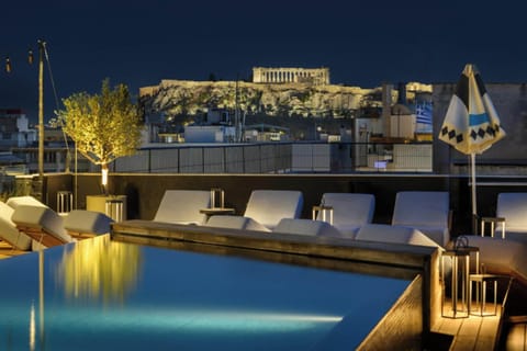 Outdoor pool, open 10:00 AM to 7:00 PM, pool umbrellas