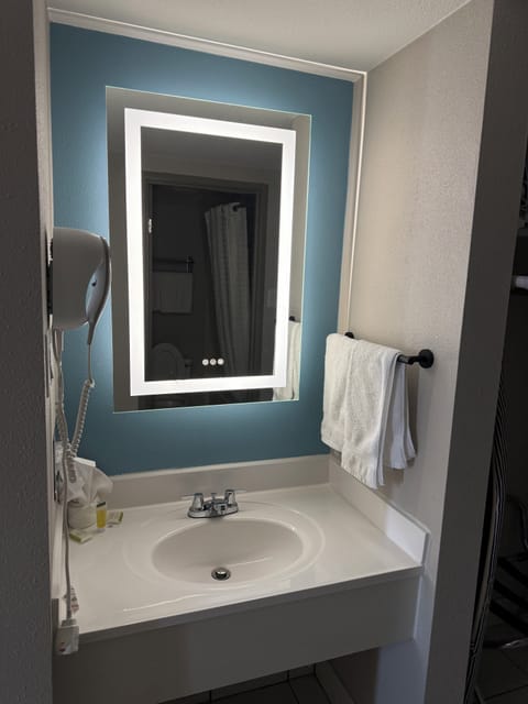 Bathtub, eco-friendly toiletries, hair dryer, towels