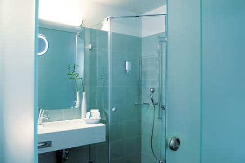 Shower, designer toiletries, hair dryer, towels