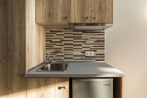 Mini-fridge, stovetop, electric kettle, cookware/dishes/utensils