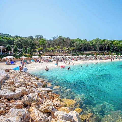 On the beach, white sand, beach umbrellas, beach bar