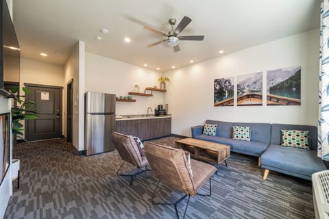 Family Suite, 1 King Bed | Living area | 55-inch Smart TV with cable channels, TV, Netflix