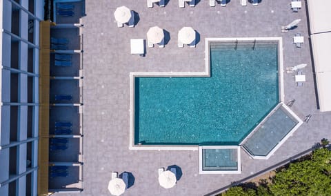 Seasonal outdoor pool, open 10:00 AM to 7:00 PM, pool umbrellas