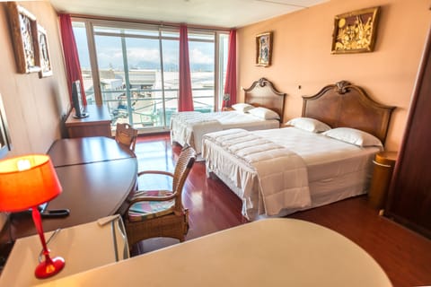 Premium Quadruple Room | Desk, blackout drapes, iron/ironing board (on request), cribs (free)