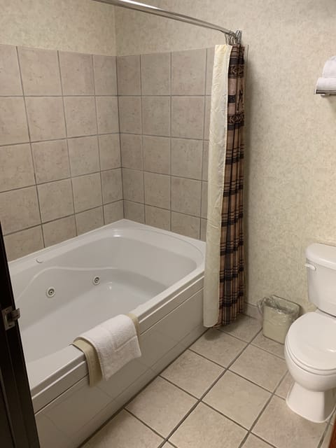 Suite, 1 King Bed with Sofa bed, Jetted Tub (King Suites Main Floor - Jetted Tub) | Bathroom | Combined shower/tub, free toiletries, hair dryer, towels