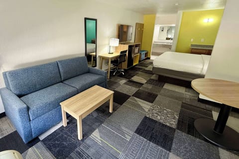 Suite, 1 King Bed, Non Smoking | Desk, laptop workspace, blackout drapes, iron/ironing board