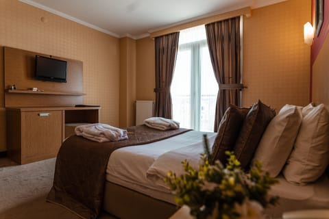 Premium bedding, desk, laptop workspace, soundproofing