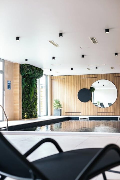 Indoor pool, open 9:00 AM to 10:00 PM, pool umbrellas