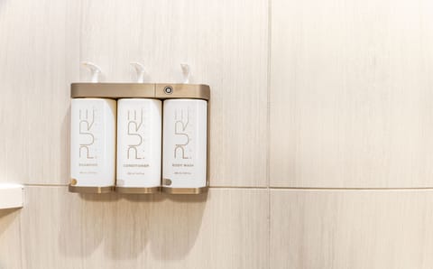 Shower, designer toiletries, hair dryer, towels