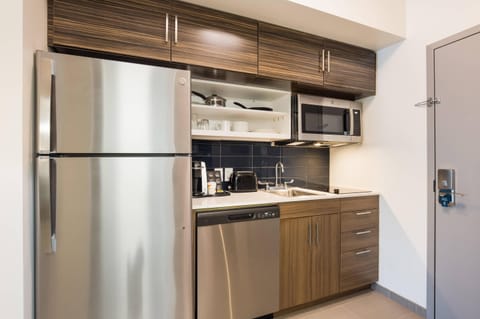 Desk, laptop workspace, iron/ironing board, bed sheets