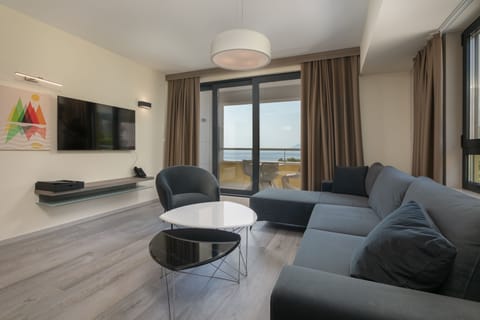 Deluxe Suite with Balcony and Sea View | Living area | 40-inch flat-screen TV with satellite channels