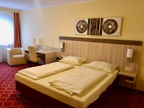 Hypo-allergenic bedding, desk, laptop workspace, blackout drapes