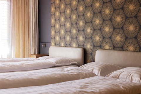 Family Quadruple Room | Down comforters, minibar, desk, laptop workspace