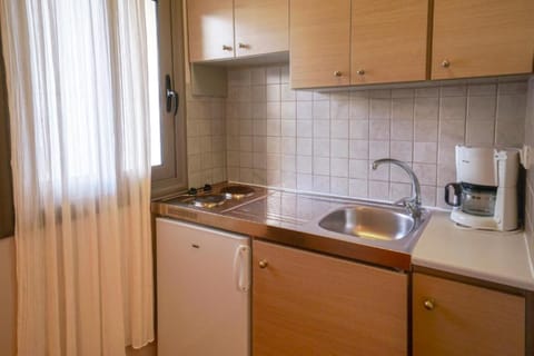 Mini-fridge, stovetop, coffee/tea maker, cookware/dishes/utensils