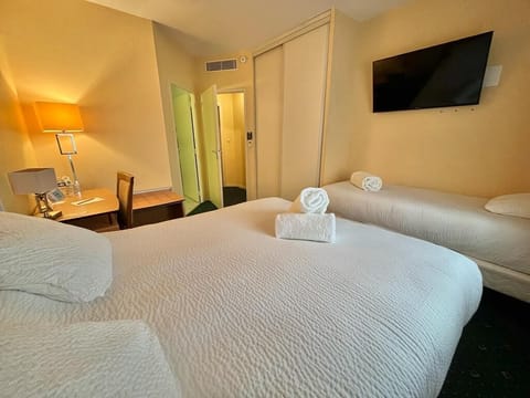 Family Room | Premium bedding, desk, laptop workspace, blackout drapes