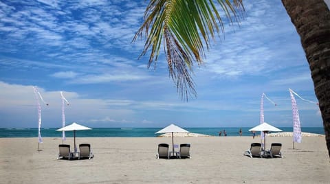On the beach, white sand, sun loungers, beach umbrellas