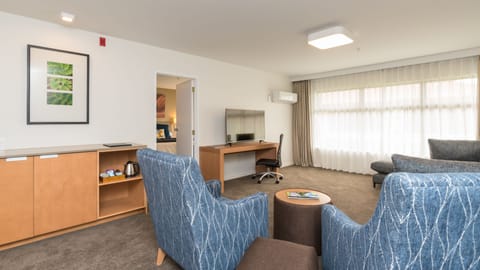 Suite, King Bed | Living area | 49-inch LCD TV with cable channels, TV