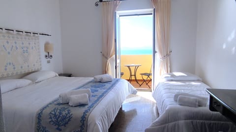 Deluxe Triple Room, Sea View | Minibar, in-room safe, desk, free WiFi